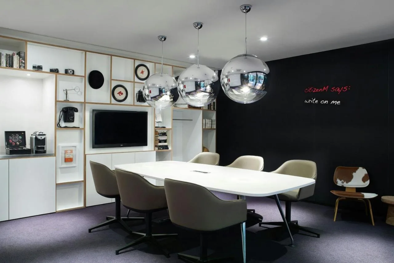 a dining room with a white table and chairs at citizenM London Bankside in London